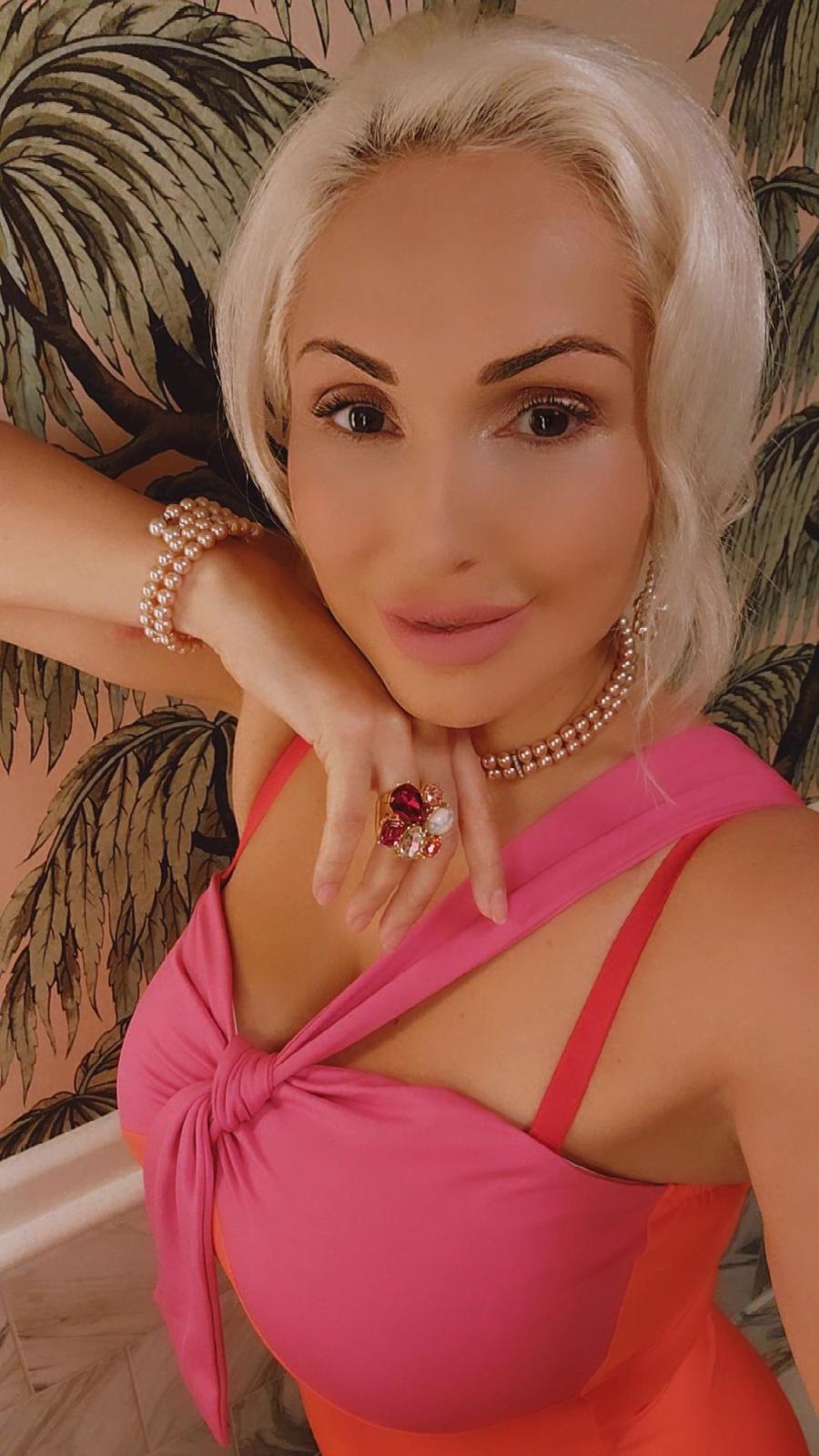 Portrait of Yanita in a pink and coral dress